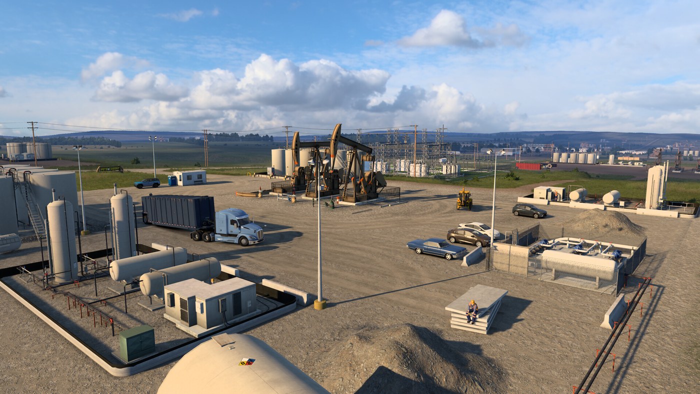 Oilfield lot with pumpjacks and a blue truck in ATS North Dakota